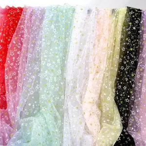 dense gold solid and white hollow stars mesh fabric