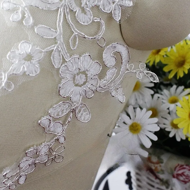 a pair of silver corded lace appliques