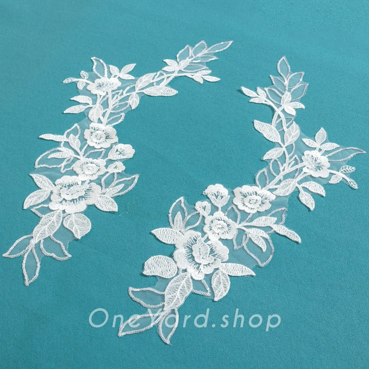 shimmering sequinned off white lace appliques
