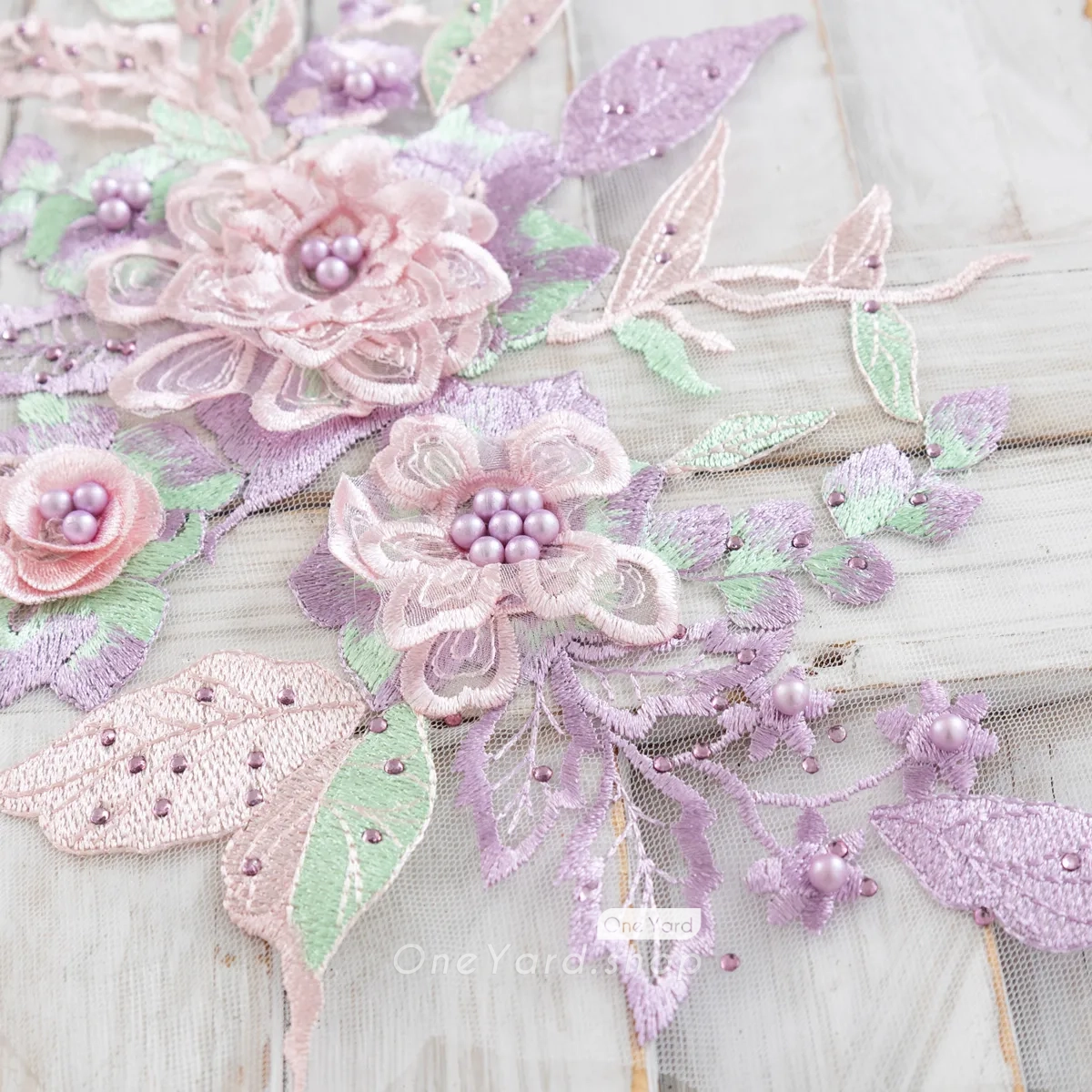 beautiful purple and greeen applique with delicate beads and pearls