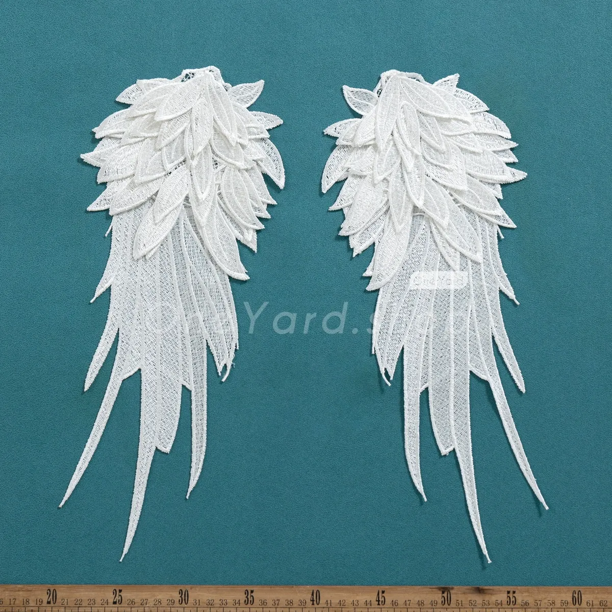 intricate Venetian embroidery wing lace motifs