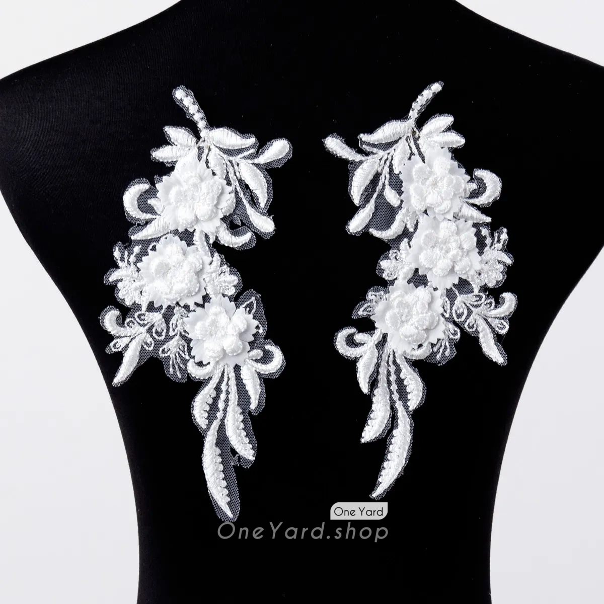 white lace applique features a pair of embroidered 3D floral designs