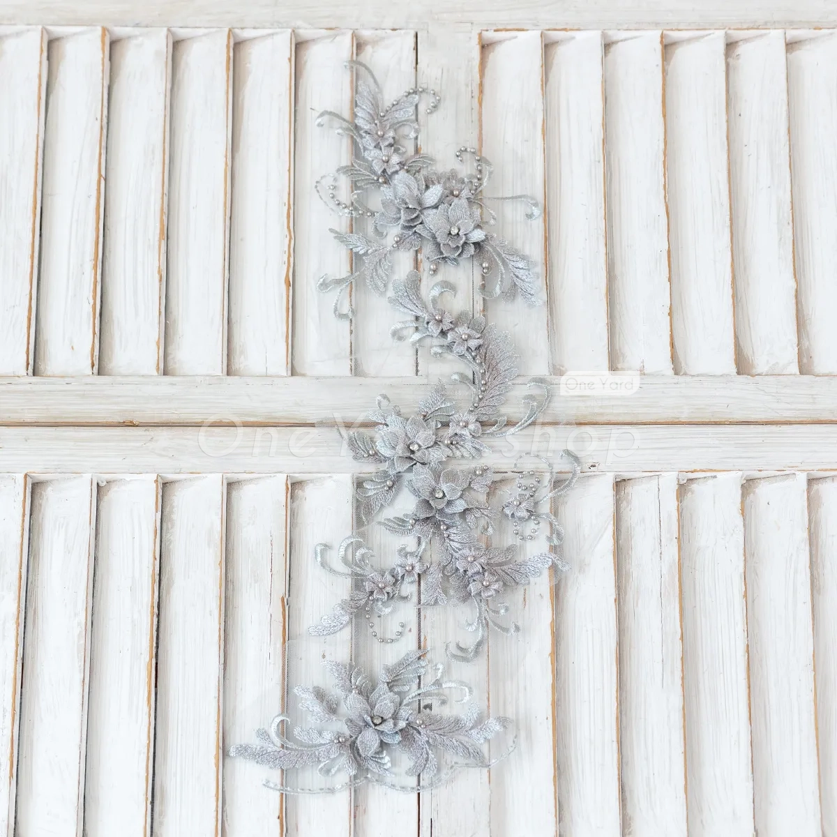 gray lace adorned with pearls and beads