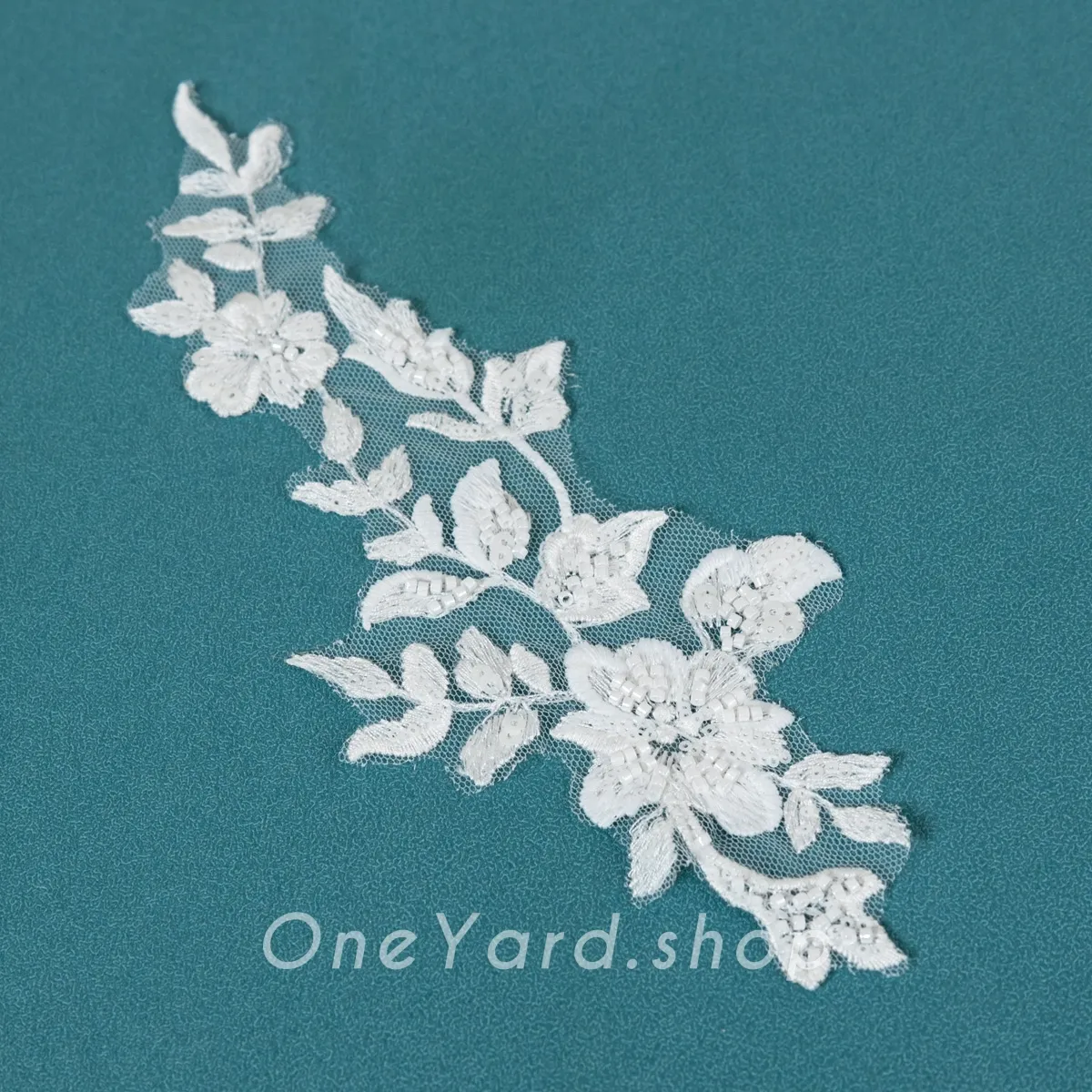 white beads and sequins adorned lace patch