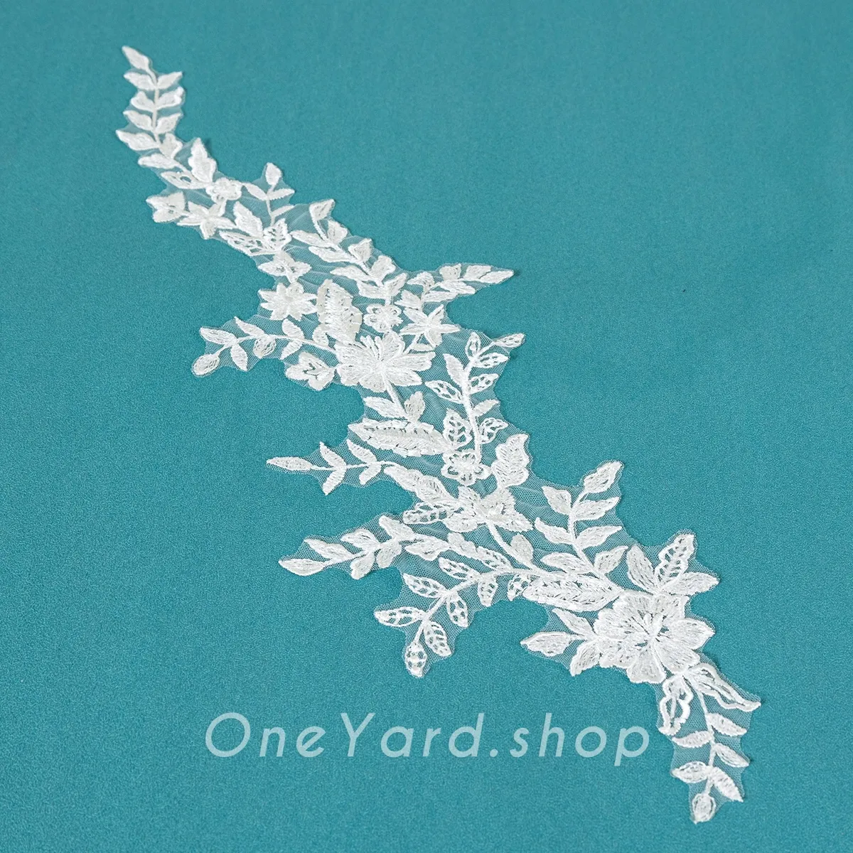 upward climbing leafy branch and blooming lace applique