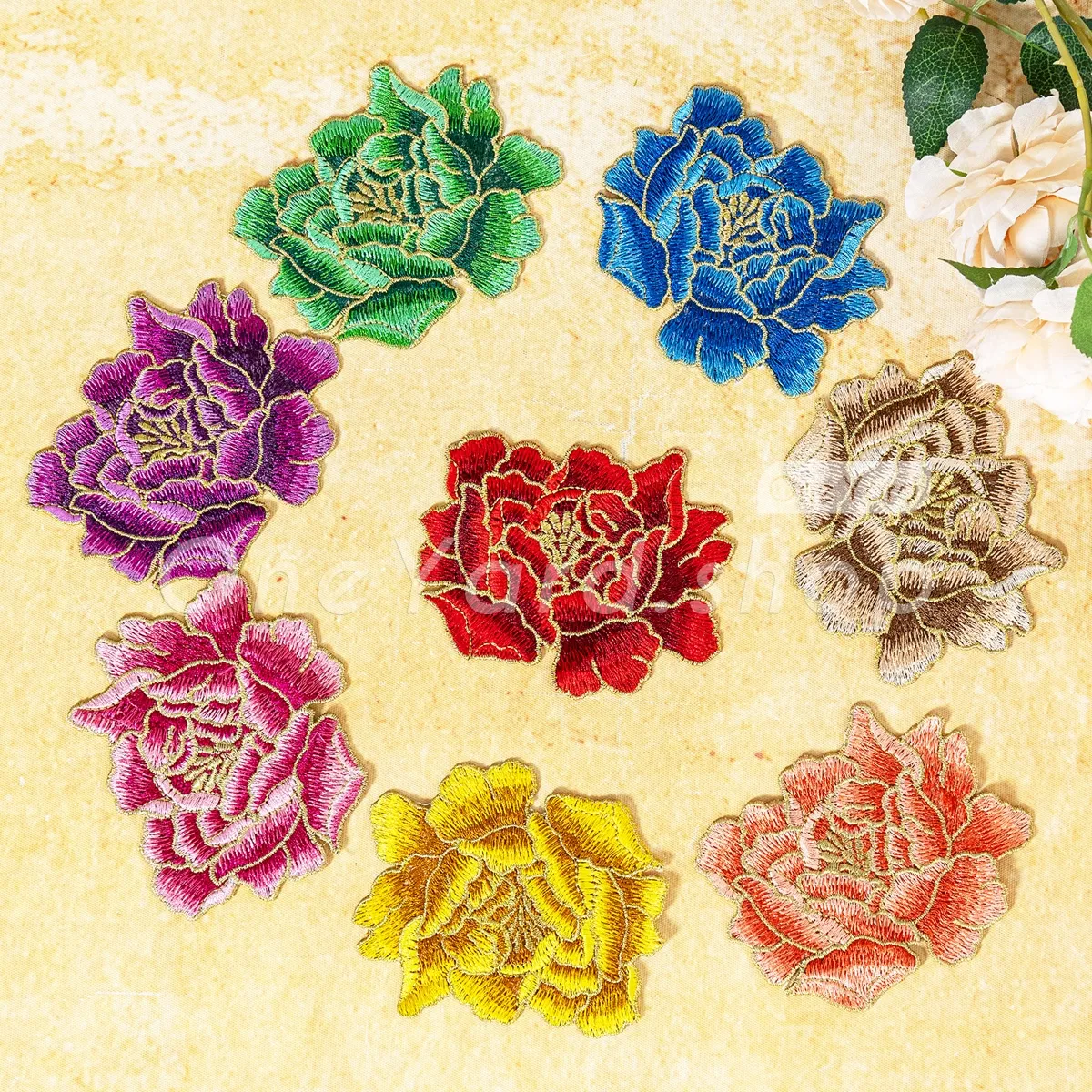 soft flat flower patch with shimmering gold thread outlining