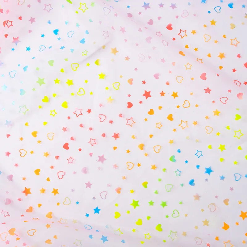 airy texture with neon bright star and heart mesh material airy texture with neon bright star and heart mesh material