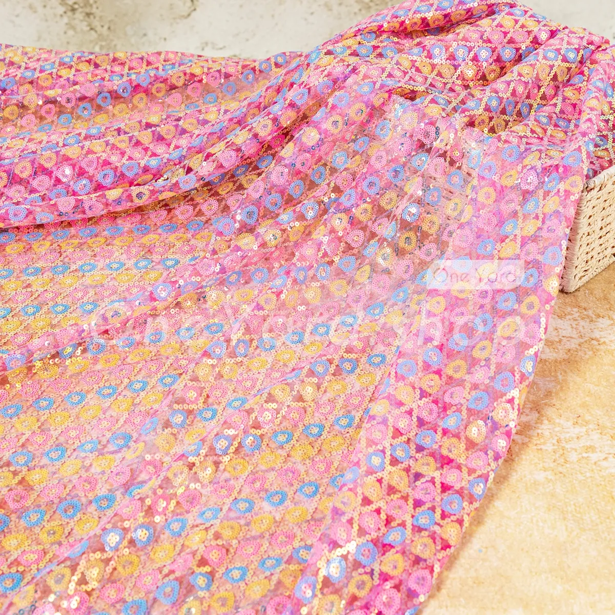 bold pink and yellow and blue sequins on fuchsia mesh fabric bold pink and yellow and blue sequins on fuchsia mesh fabric