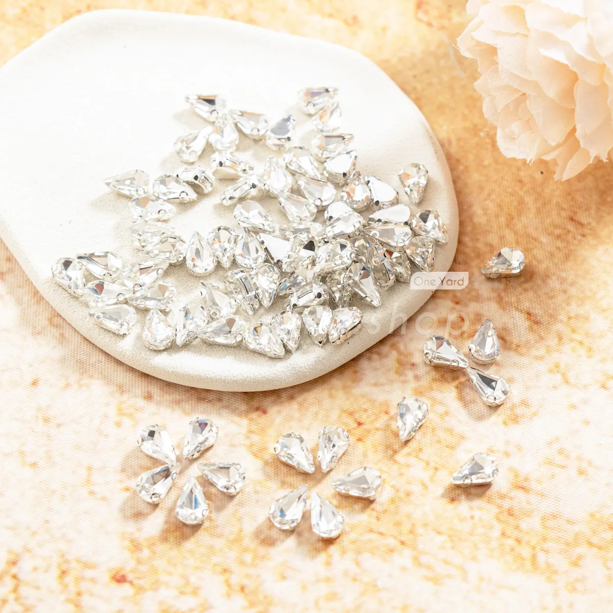 crystal clear gems encased in a silver tone metal setting crystal clear gems encased in a silver tone metal setting